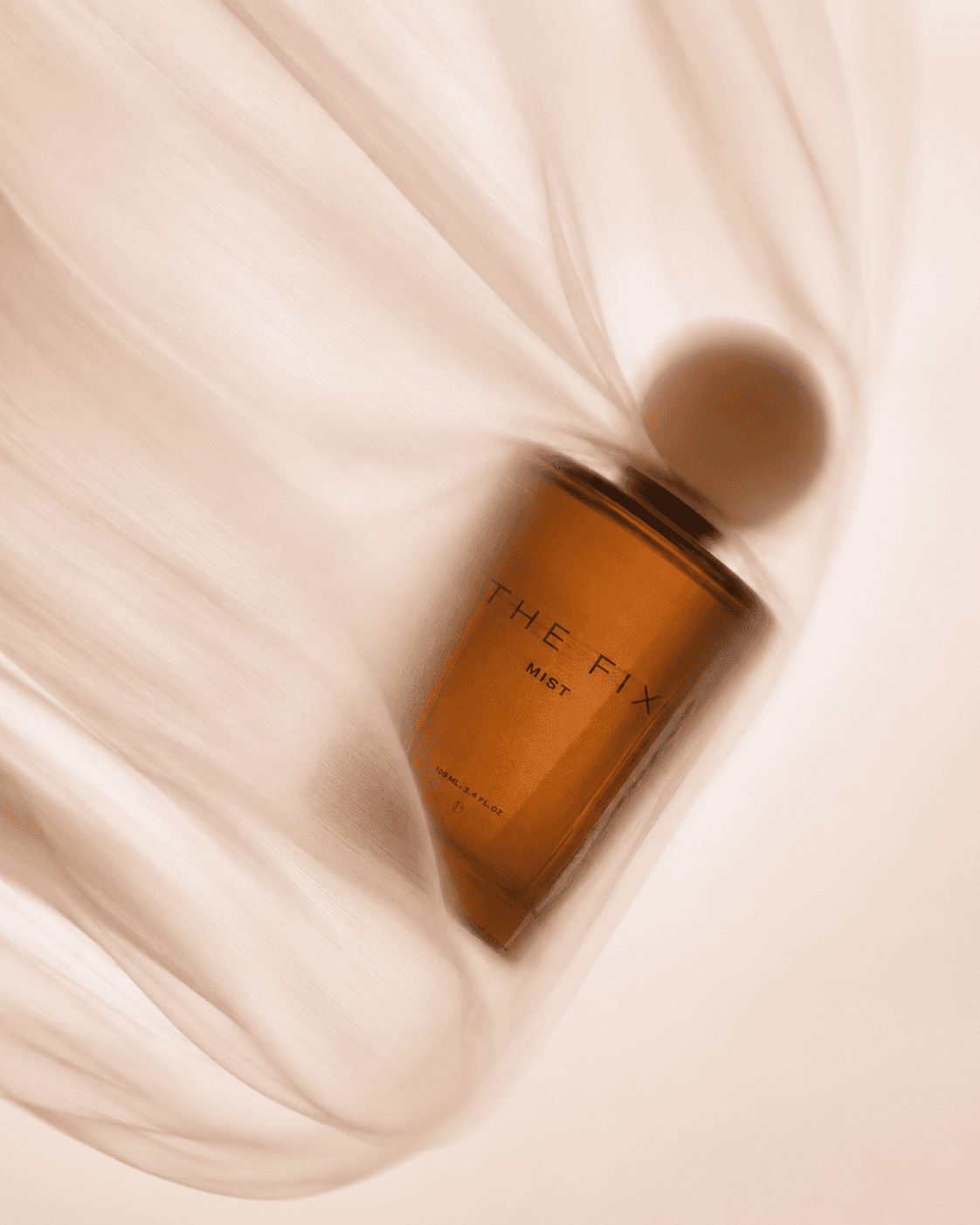 Amber mist bottle wrapped in sheer fabric